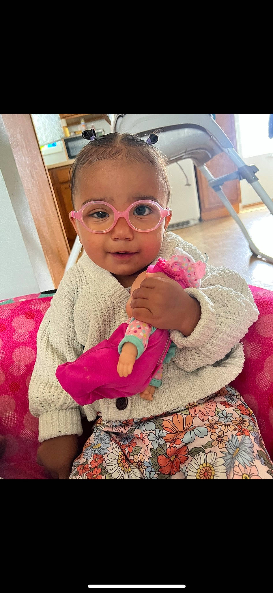 Kaisley is registered to the contest to win money with this photo: baby_toddler_clothing, cheek, child, comfort, ear, eye, eyewear, flooring, fun, glasses, happy, lip, magenta, nose, person, pink, sitting, skin, sleeve, toddler