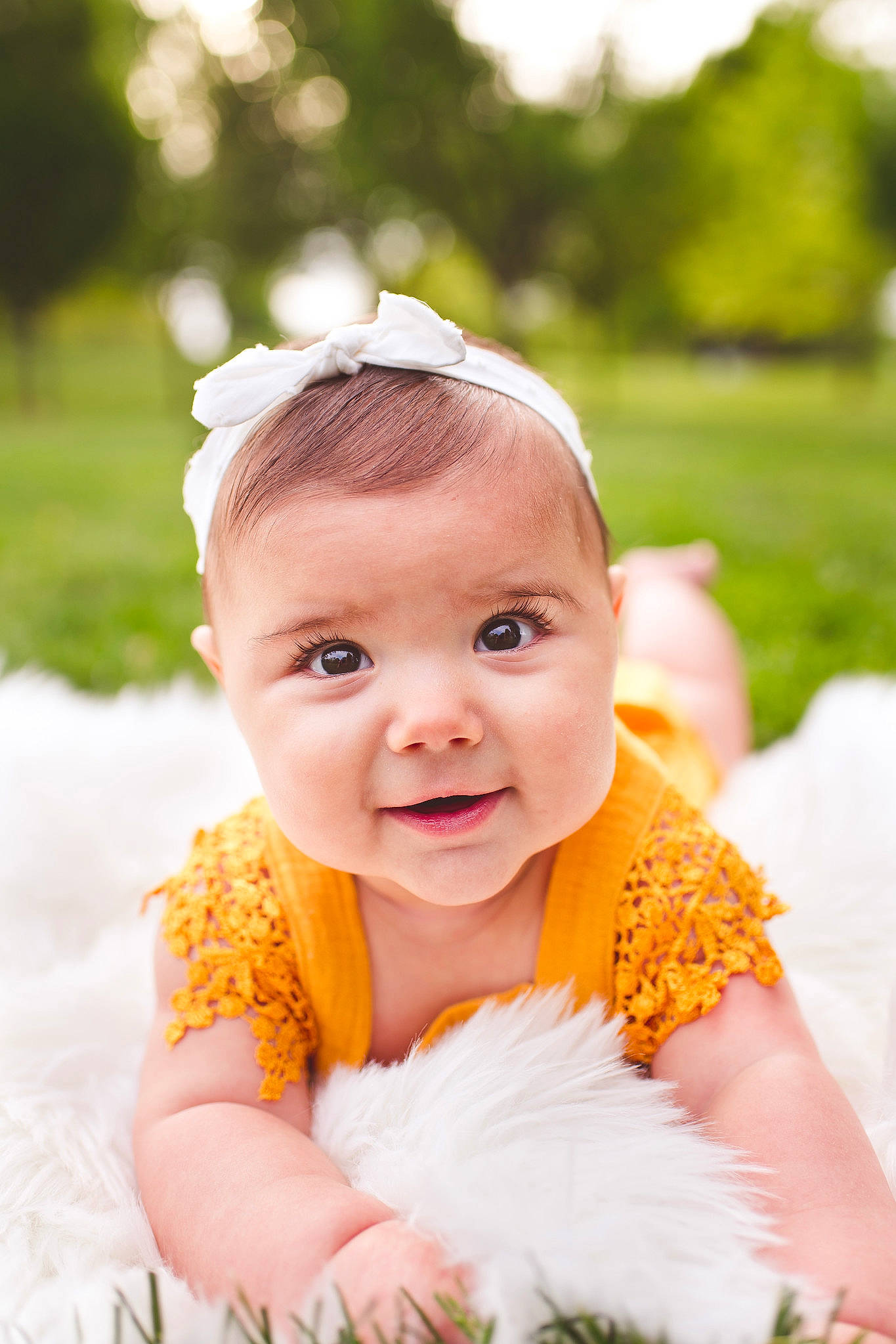 Phoebe is registered to the contest to win money with this photo: baby, baby_toddler_clothing, bridal_clothing, child, dress, fashion_accessory, flash_photography, gesture, grass, happy, headpiece, leisure, people_in_nature, person, plant, sitting, skin, smile, toddler, tradition