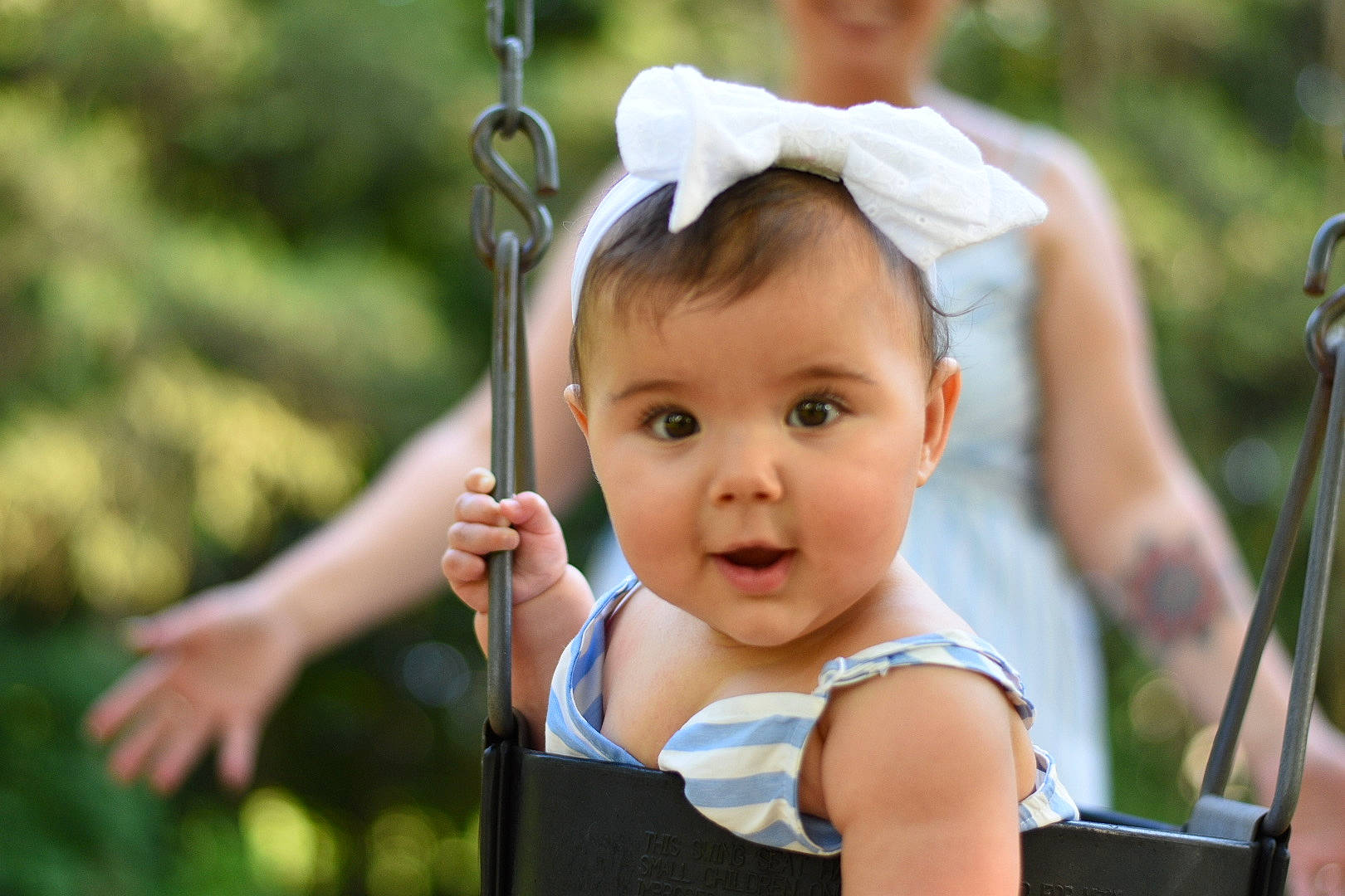Phoebe is registered to the contest to win money with this photo: baby, baby_products, baby_toddler_clothing, child, city, event, eye, fun, gesture, grass, happy, leisure, people_in_nature, person, photograph, recreation, summer, swing, toddler, tree