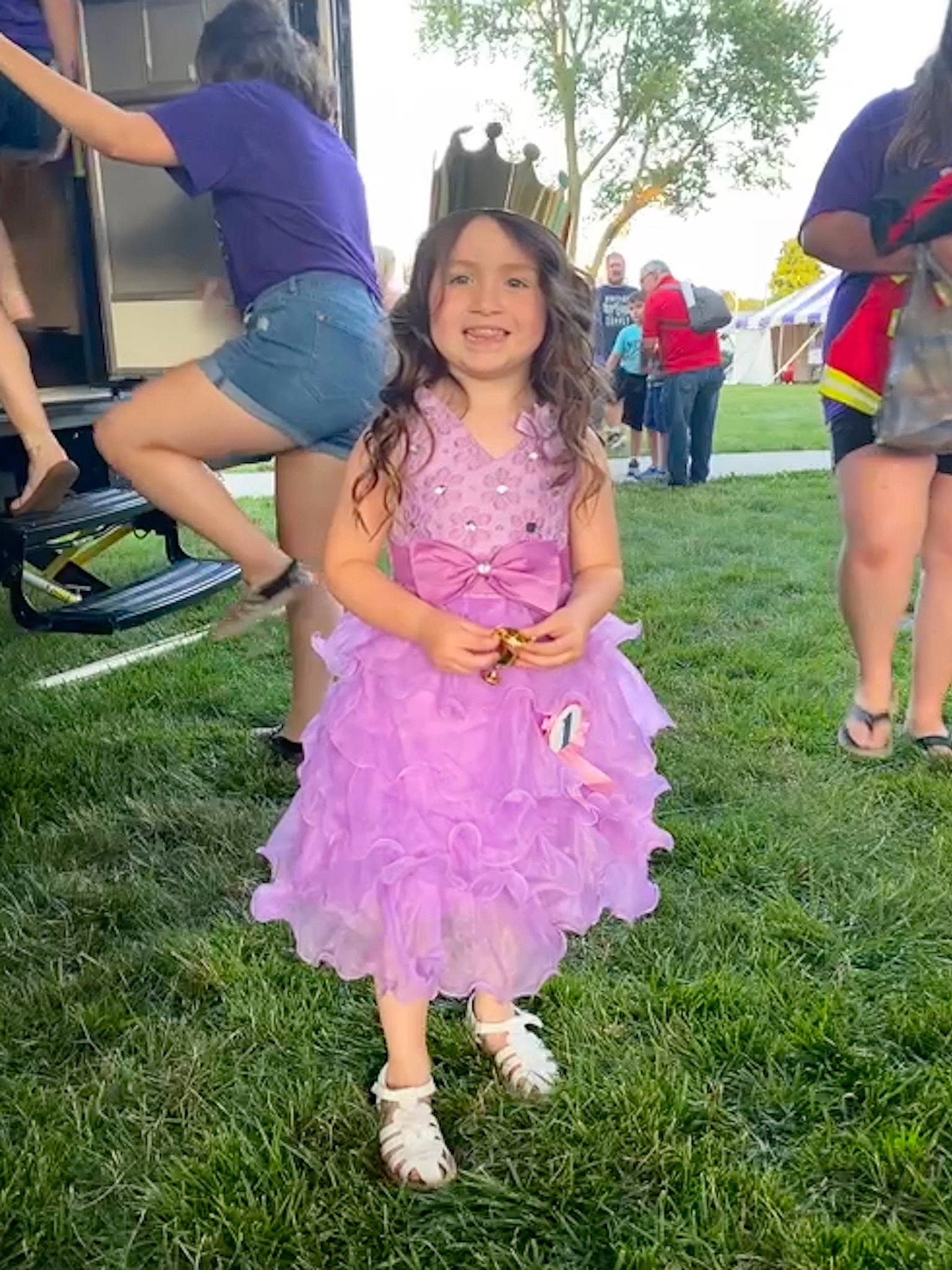 Emalyn is registered to the contest to win money with this photo: clothing, event, fun, grass, happy, joy, lawn, leisure, magenta, person, pink, plant, pole, recreation, shoe, shorts, sky, smile, sneakers, t_shirt