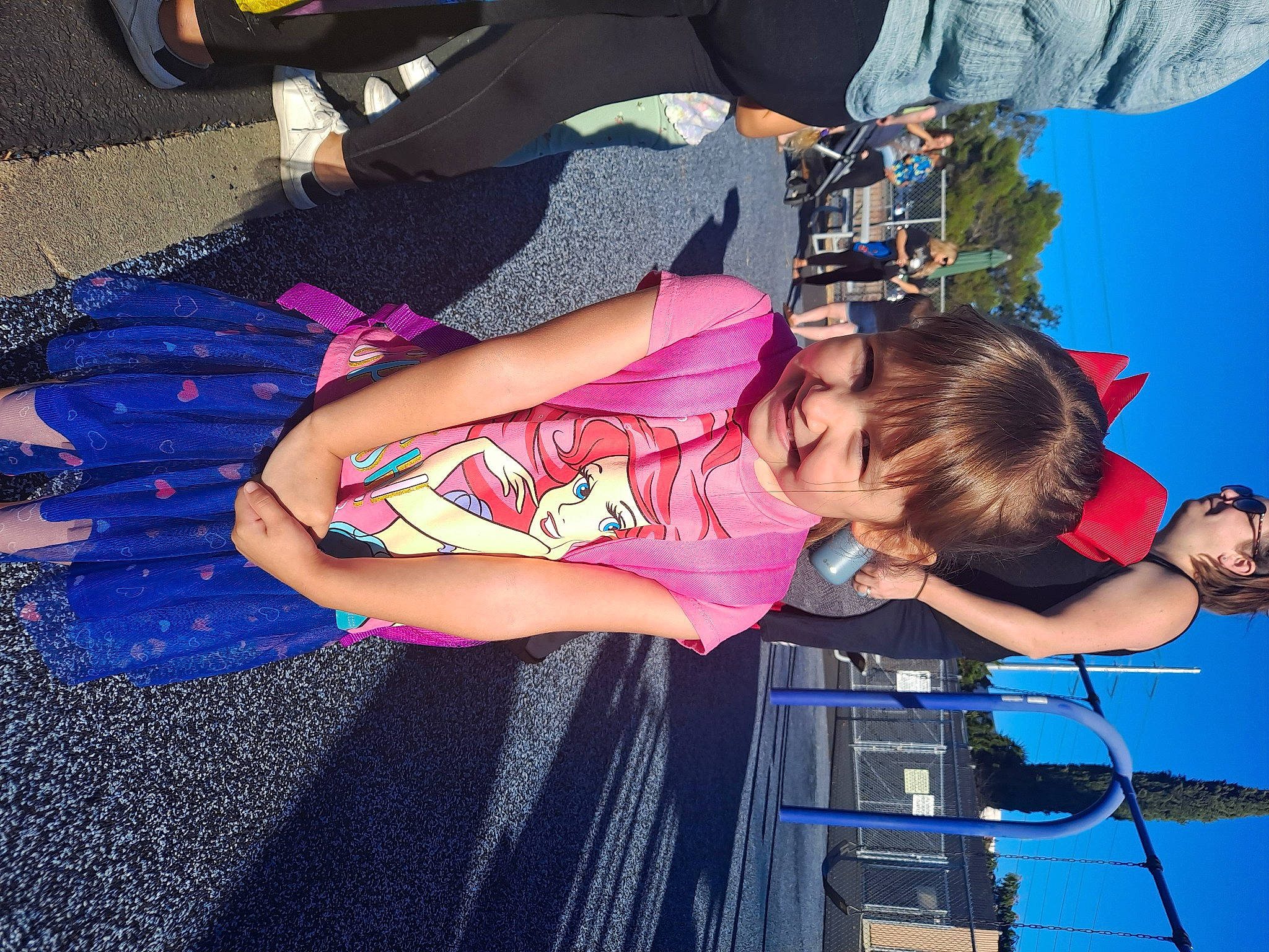 Nevaeh is registered to the contest to win money with this photo: arm, audio_equipment, blue, electric_blue, entertainment, event, fun, human_leg, joy, leisure, luggage_and_bags, magenta, person, public_event, recreation, t_shirt, thigh, tree