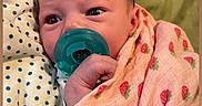 Brooklynn is registered to the contest to win money with this photo: baby, infant, child, portrait, face, eyes, pacifier, blanket, swaddle, strawberry, pink, green, polka_dots, lying_down, cozy, indoors, bed, close_up, relaxed, photography