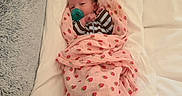 Brooklynn is registered to the contest to win money with this photo: baby, bed, blanket, calm, child, couch, cozy, face, home, indoor, infant, newborn, pacifier, pillow, portrait, sleeping, strawberry_pattern, striped_clothing, swaddled, textile