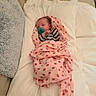 Brooklynn is registered to the contest to win money with this photo: newborn, baby, infant, child, sleeping, pacifier, swaddled, blanket, strawberry_pattern, striped_clothing, bed, pillow, couch, indoor, portrait, face, calm, cozy, textile, home