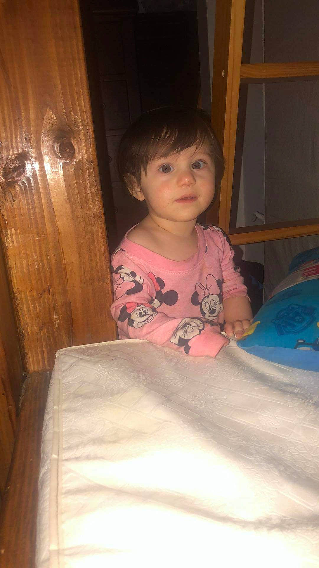 Ellianna is registered to the contest to win money with this photo: baby, bedding, cheek, child, comfort, eye, facial_expression, fun, happy, head, linens, nose, person, room, sitting, skin, smile, t_shirt, toddler, vacation