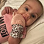 Madilynn joined the competition — help win amazing prizes! baby, infant, teething_mitten, leopard_print, pink_clothing, lying_down, wide_eyes, hand, face, cute, soft_surface, close_up, child, mouth, skin, newborn, comfort, small_person, indoors, relaxed