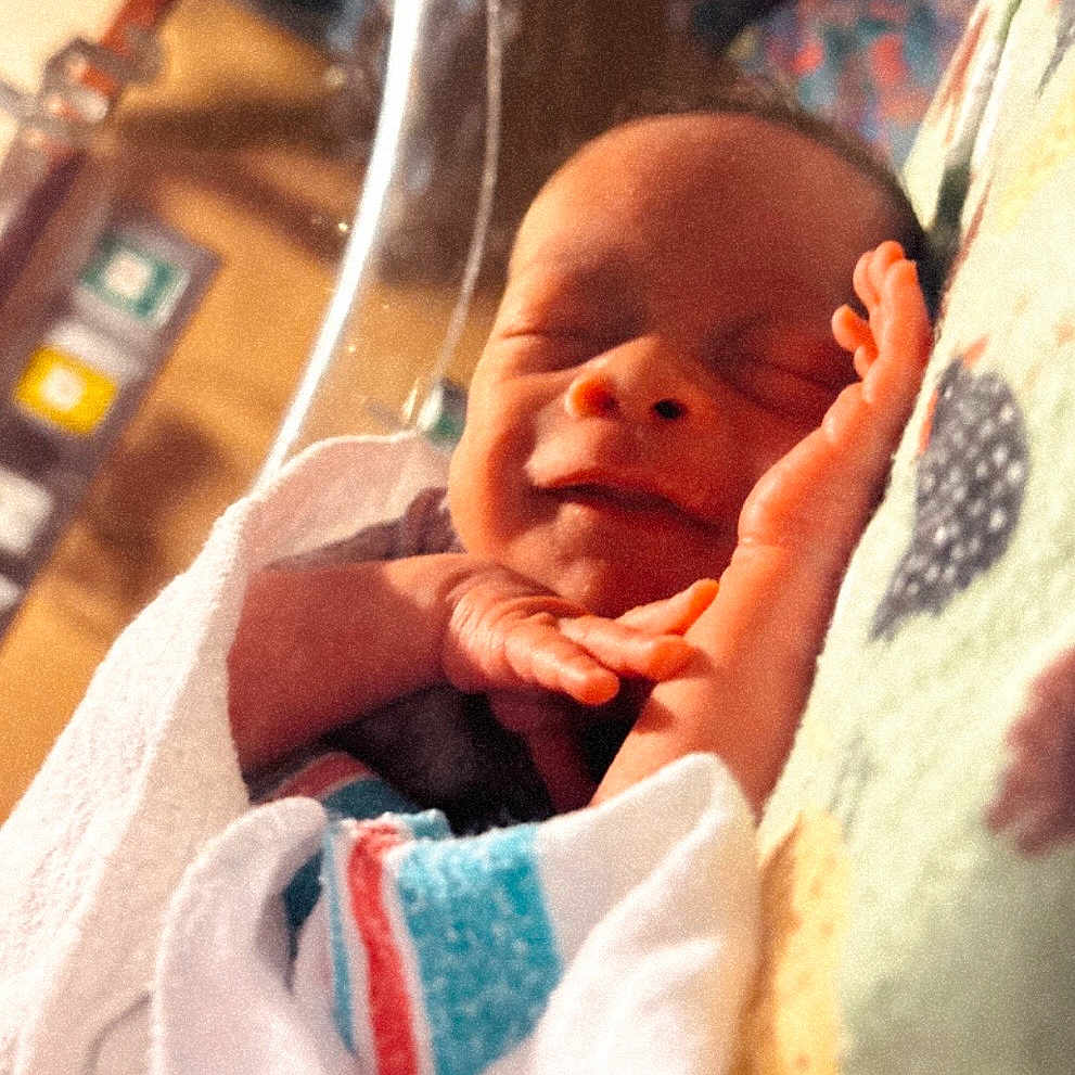 Rodney joined the competition — help win amazing prizes! baby, blanket, child, closeup, cozy, cute, face, hand, hospital, human, indoors, infant, newborn, peaceful, portrait, resting, sleeping, soft_lighting, toddler, wrapped