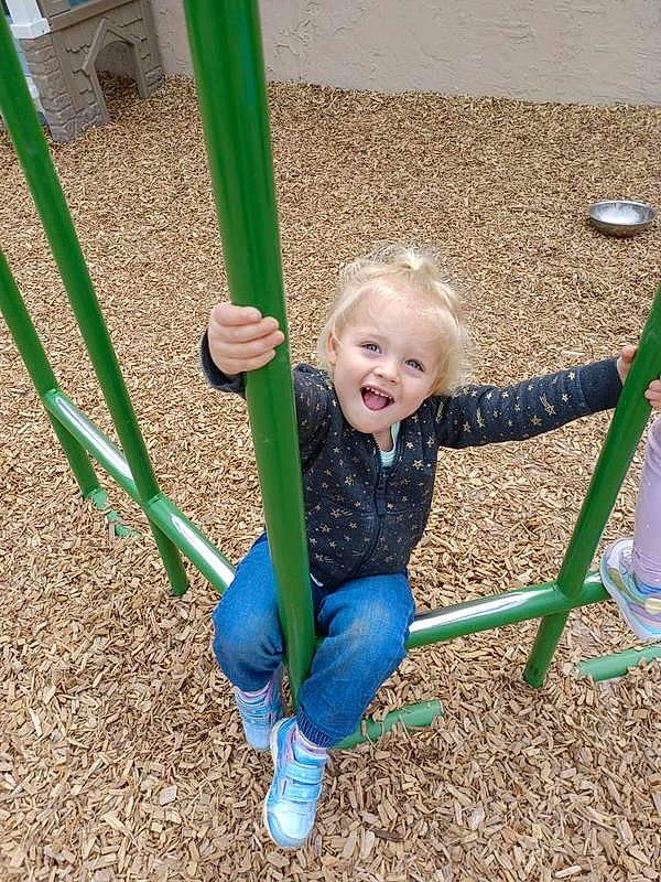 Makayla is registered to the contest to win money with this photo: child, city, electric_blue, facial_expression, fun, grass, grass_family, green, happy, leisure, outdoor_play_equipment, people_in_nature, person, play, playground, recreation, smile, soil, swing, toddler