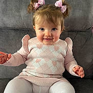 Dulcie is registered to the contest to win money with this photo: baby, blue_eyes, child, clothing, couch, cozy, cute, girl, gray_couch, hair_bows, hearts, indoors, pigtails, pink_sweater, portrait, sitting, smile, toddler, white_tights, young_child