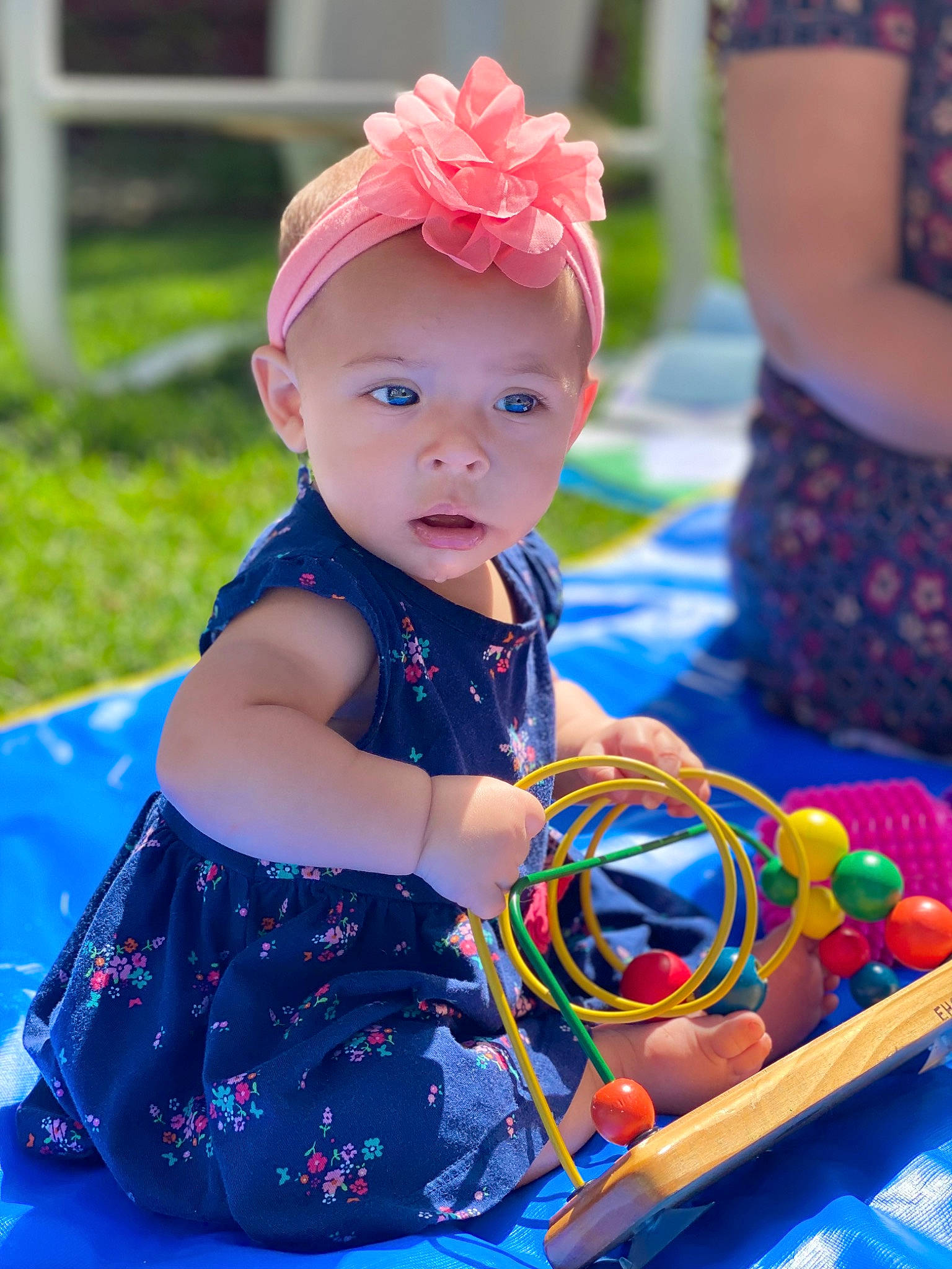 Avangeline is registered to the contest to win money with this photo: baby, baby_toddler_clothing, blue, child, dress, electric_blue, event, fun, happy, hat, headband, headwear, leisure, magenta, party_supply, person, pink, purple, recreation, sitting