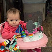 Emmalynn joined the competition — help win amazing prizes! baby, child, infant, portrait, sitting, activity_center, baby_toy, colorful_toys, pink, playroom, indoors, home, plastic_toy, stuffed_animal, bird_toy, curious, looking_at_camera, long_sleeves, wood_floor, storage_bin
