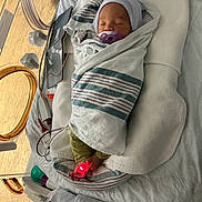 Jakaidens is registered to the contest to win money with this photo: baby, bed, blanket, cute, foot_sensor, healthcare, hospital, indoors, infant, medical_equipment, monitoring, neonatal, newborn, pacifier, person, resting, sleeping, swaddled, toddler, wrapped