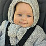 baby, child, hoodie, fluffy_clothing, car_seat, harness, smile, face, blue_eyes, cute, infant, closeup, portrait, young, outdoor, warm_clothing, seatbelt, soft_texture, safety, adorable