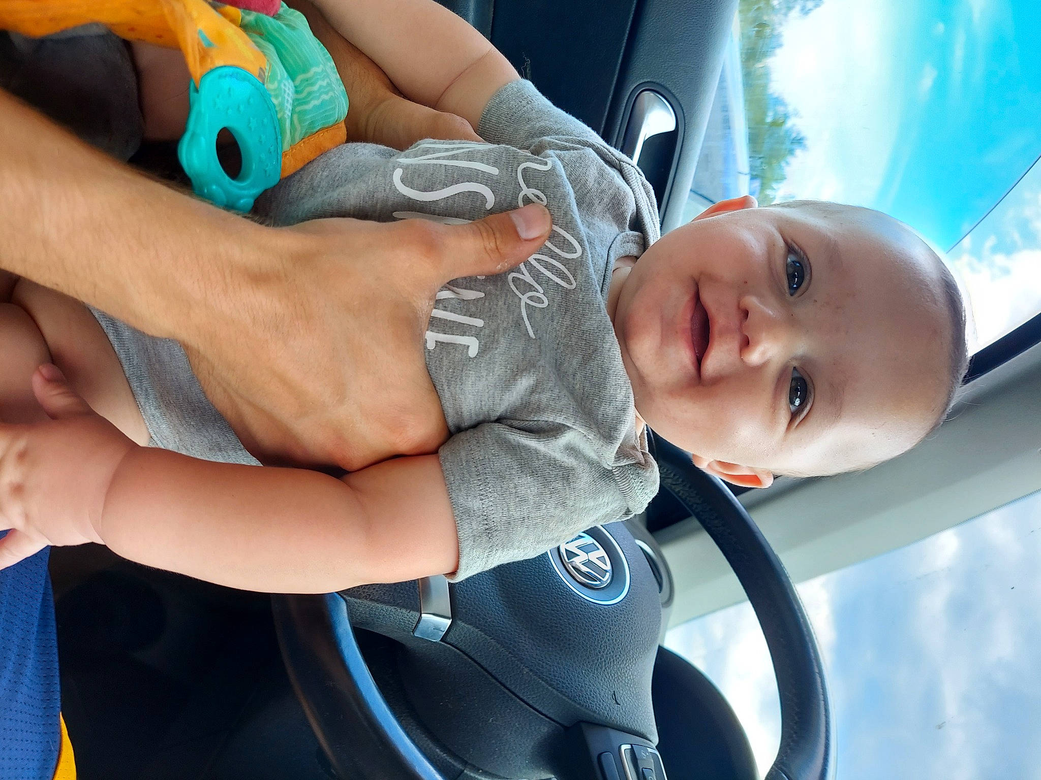Harlan is registered to the contest to win money with this photo: auto_part, azure, blue, car, child, elbow, electric_blue, finger, gesture, hand, happy, knee, leisure, mouth, nail, person, skin, thigh, thumb, toddler