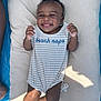 Ropyr joined the competition — help win amazing prizes! baby, smiling, infant, blanket, onesie, striped_clothing, text_on_clothing, happy, hands, feet, toes, curly_hair, outdoor, sunlight, shadow, lying_down, person, closeup, child, casual
