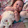 baby, blanket, bottle, child, cozy, cuddly, cute, easter, fabric, face, hand, heart_pattern, indoor, infant, pink, plush_toy, resting, sleepwear, soft_toy, stuffed_animal