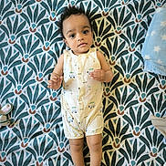 éden Naël a rejoint le concours — aidez-le/la à gagner de superbes lots ! baby, infant, child, romper, patterned_bedspread, lying_down, indoor, toy_shoe, blanket, curly_hair, looking_up, footwear, soft_toy, cute, small_hands, sleeping_area, fabric, expression, peaceful, comfortable