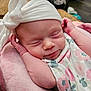 Elizabeth is registered to the contest to win money with this photo: baby, sleeping, infant, headwear, bow, blanket, pink, floral, soft, cushion, closeup, face, peaceful, resting, newborn, cute, skin, indoors, cozy, portrait