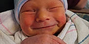 Elizabeth is registered to the contest to win money with this photo: newborn, baby, smile, hat, striped_hat, blanket, hospital_blanket, hand, closeup, face, infant, sleeping, cute, wrapped, person, skin, newborn_baby, baby_clothing, resting, portrait