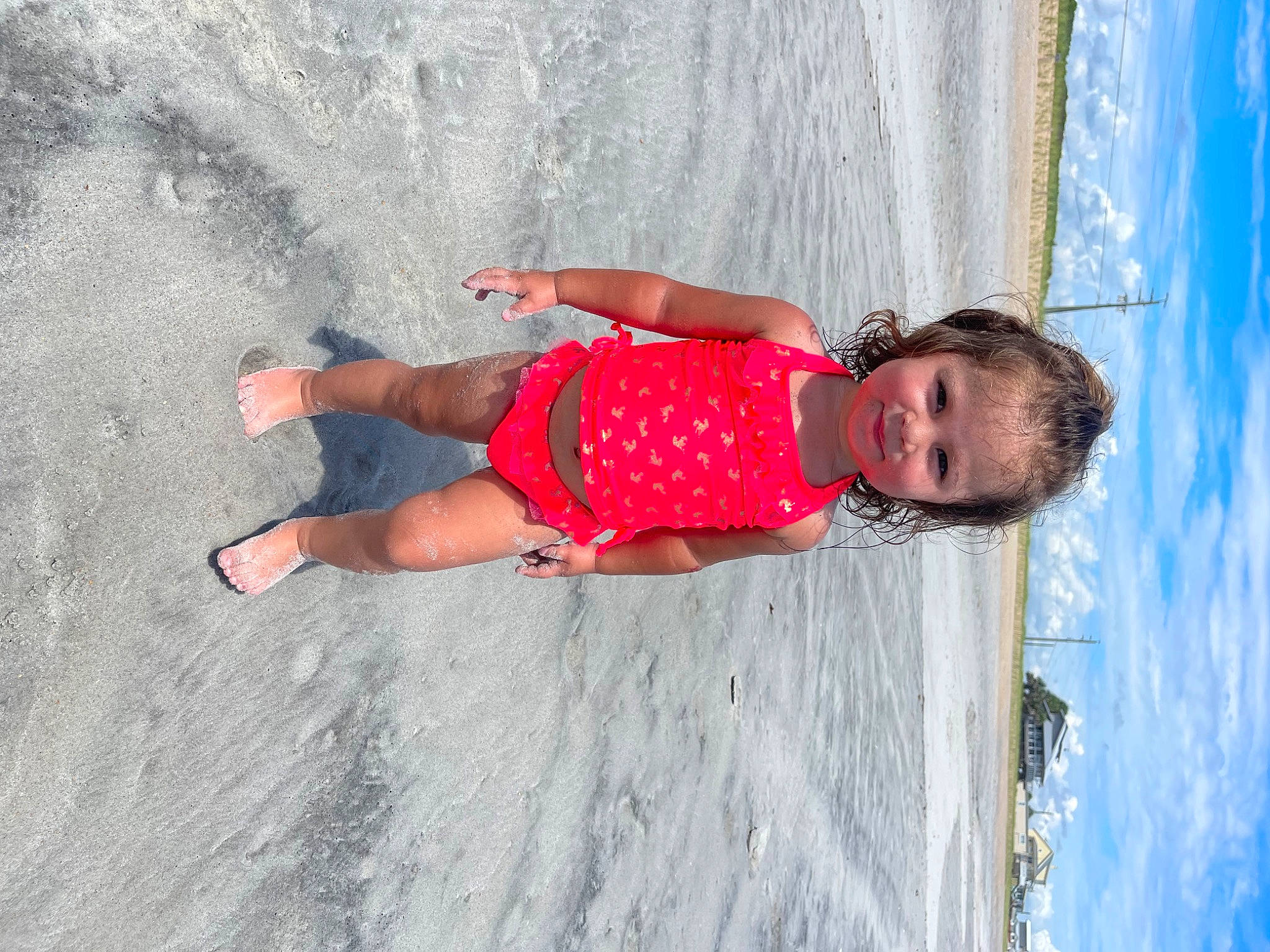Collette is registered to the contest to win money with this photo: beach, blue, child, electric_blue, fun, happy, human_leg, joy, leisure, pattern, people_in_nature, person, recreation, sand, sky, smile, thigh, toddler, travel, waist
