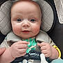 Gunnar is registered to the contest to win money with this photo: baby, baby_accessory, blue_eyes, car_seat, child, child_seat, closeup, cute, expression, face, hands, indoor, infant, infant_clothing, pacifier, person, portrait, safety_harness, skin, toy