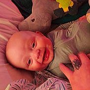 Gunnar joined the competition — help win amazing prizes! baby, bed, blanket, child, closeup, clothing, comfort, cozy, cute, face, hand, happy, hippo, indoor, infant, person, pillow, plush_toy, smile, tattoo