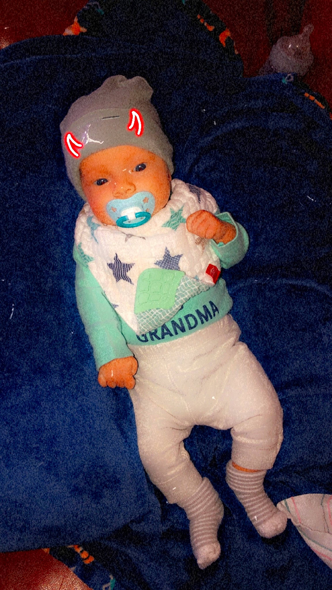 Phoenix is registered to the contest to win money with this photo: arm, art, baby, baby_toddler_clothing, cap, child, costume_hat, doll, electric_blue, fictional_character, hat, human_body, linens, pattern, person, plush, sleeve, stuffed_toy, textile, toy