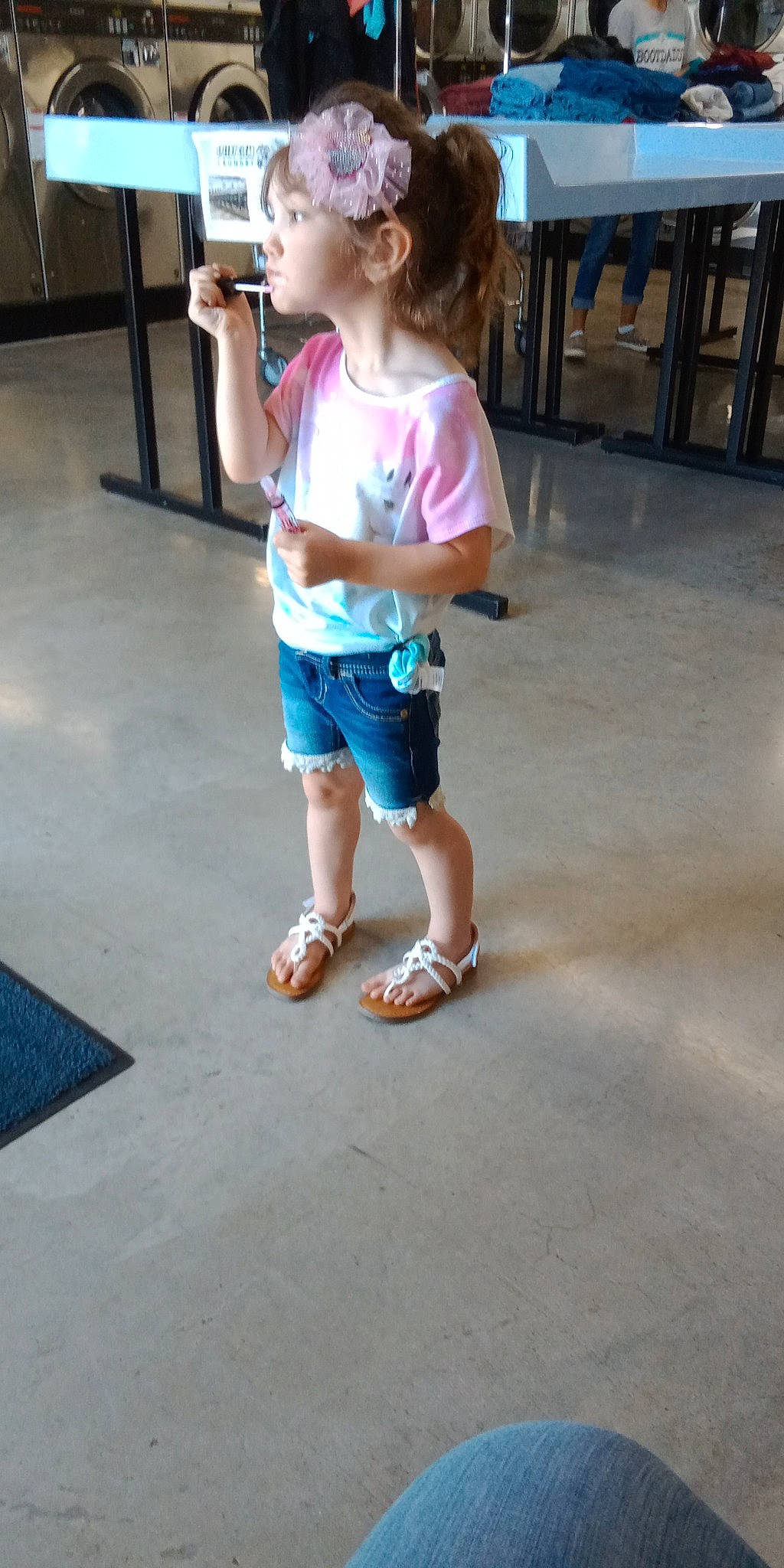 Baylee is registered to the contest to win money with this photo: calf, child, electric_blue, flooring, foot, fun, human_leg, joint, knee, leisure, person, recreation, sandal, shorts, sleeve, slipper, t_shirt, thigh, toddler, waist
