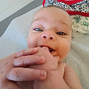 Leanne joined the competition — help win amazing prizes! baby, blanket, chewing, child, closeup, clothing, curious, cute, expression, face, foot, hand, happy, indoors, infant, lying_down, person, playful, skin, young