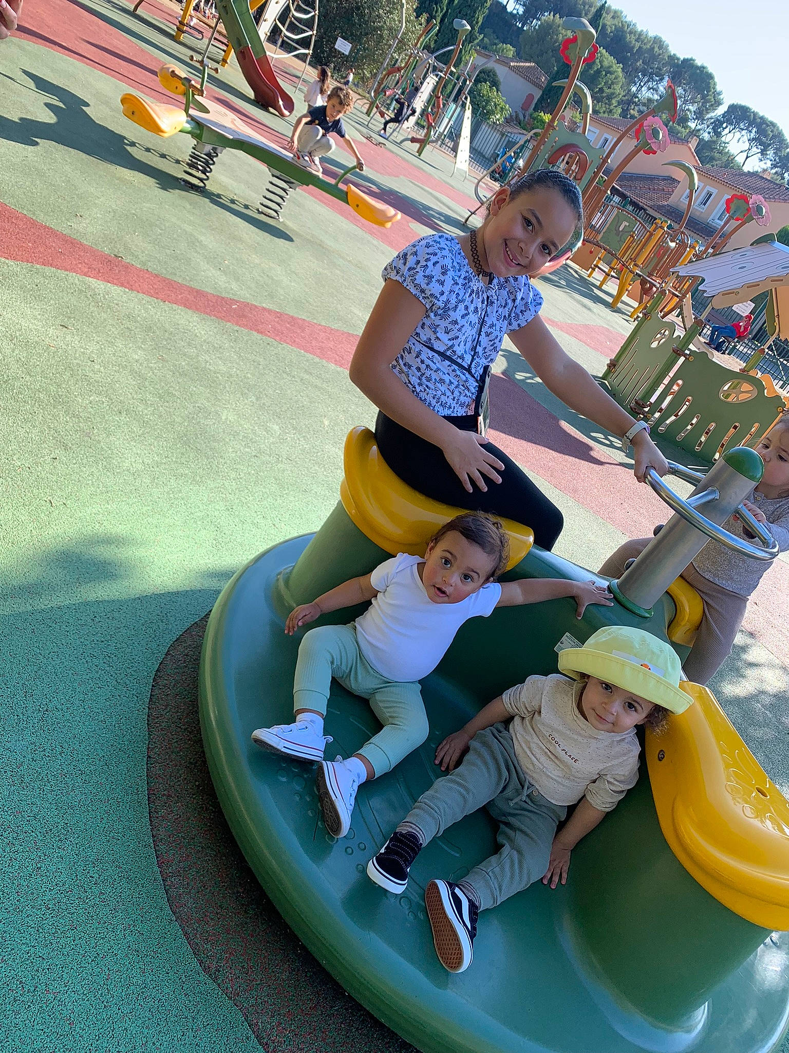 Lyana participe au concours pour gagner de l'argent avec cette photo : amusement_ride, bumper, child, city, event, fun, happy, hat, headwear, joy, leisure, nonbuilding_structure, outdoor_play_equipment, outdoor_recreation, person, playground, recreation, shorts, sky, smile
