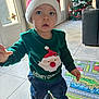 Rafaël participe au concours pour gagner de l'argent avec cette photo : toddler, child, indoor, christmas_tree, holiday, festive_clothing, santa_hat, green_sweater, toy_car, play_mat, curious, floor_tiles, living_room, holiday_decorations, person, smiling, cute, home, christmas, seasonal