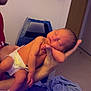 Arabella is registered to the contest to win money with this photo: newborn, baby, man, holding, sleeping, diaper, hand, face, indoor, blanket, bed, person, skin, closeup, parent, care, rest, peaceful, gentle, family