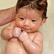 Audrey is registered to the contest to win money with this photo: adorable, adult_hand, baby, bath, bubbles, child, closeup, cute, expression, face, fingers, hand, infant, newborn, person, portrait, skin, water, wet_hair, young