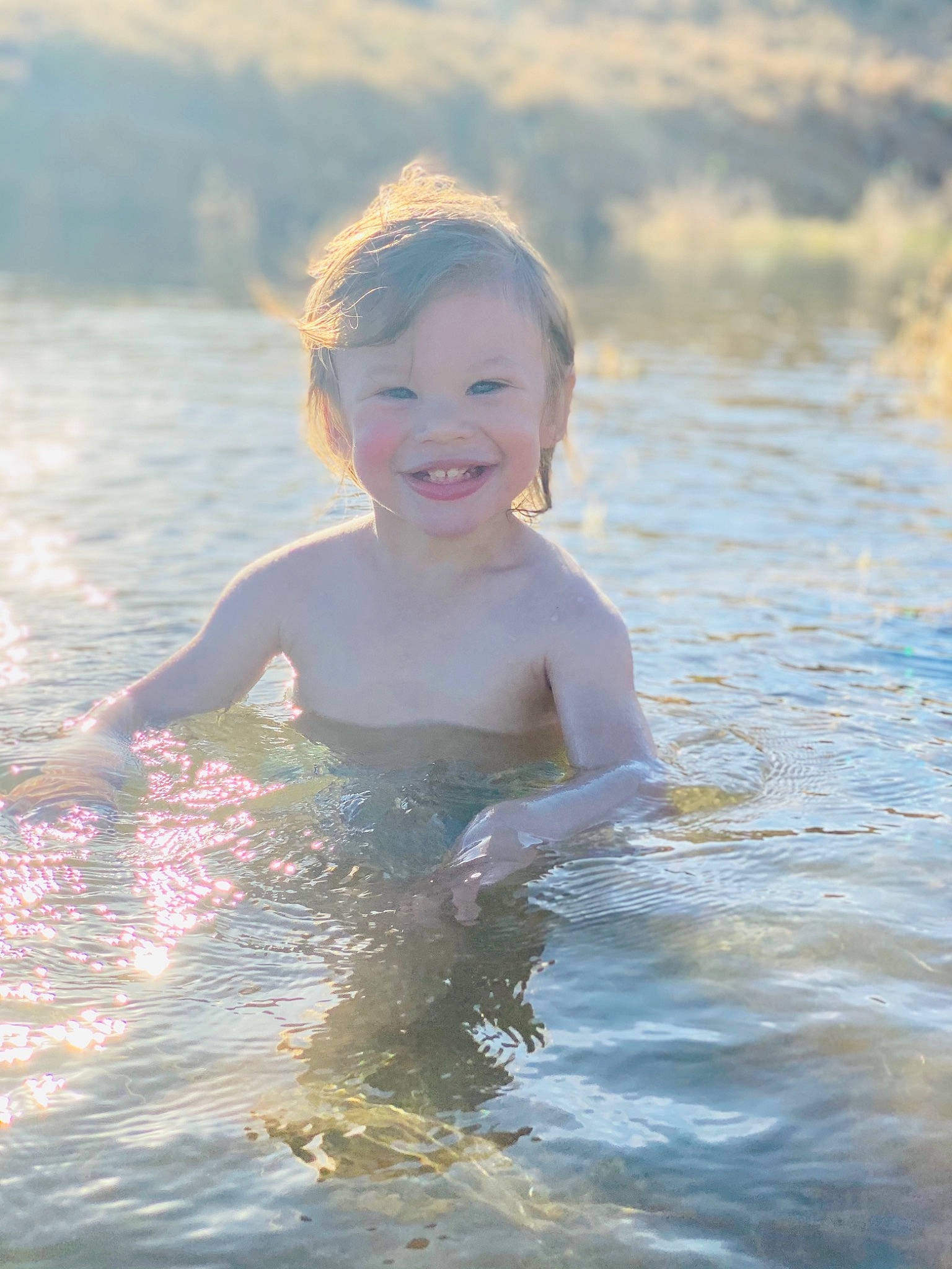 Kristopher is registered to the contest to win money with this photo: bathing, child, eye, flash_photography, fun, hair, happy, head, human_body, joy, lake, leisure, morning, people_in_nature, people_on_beach, person, recreation, skin, smile, toddler