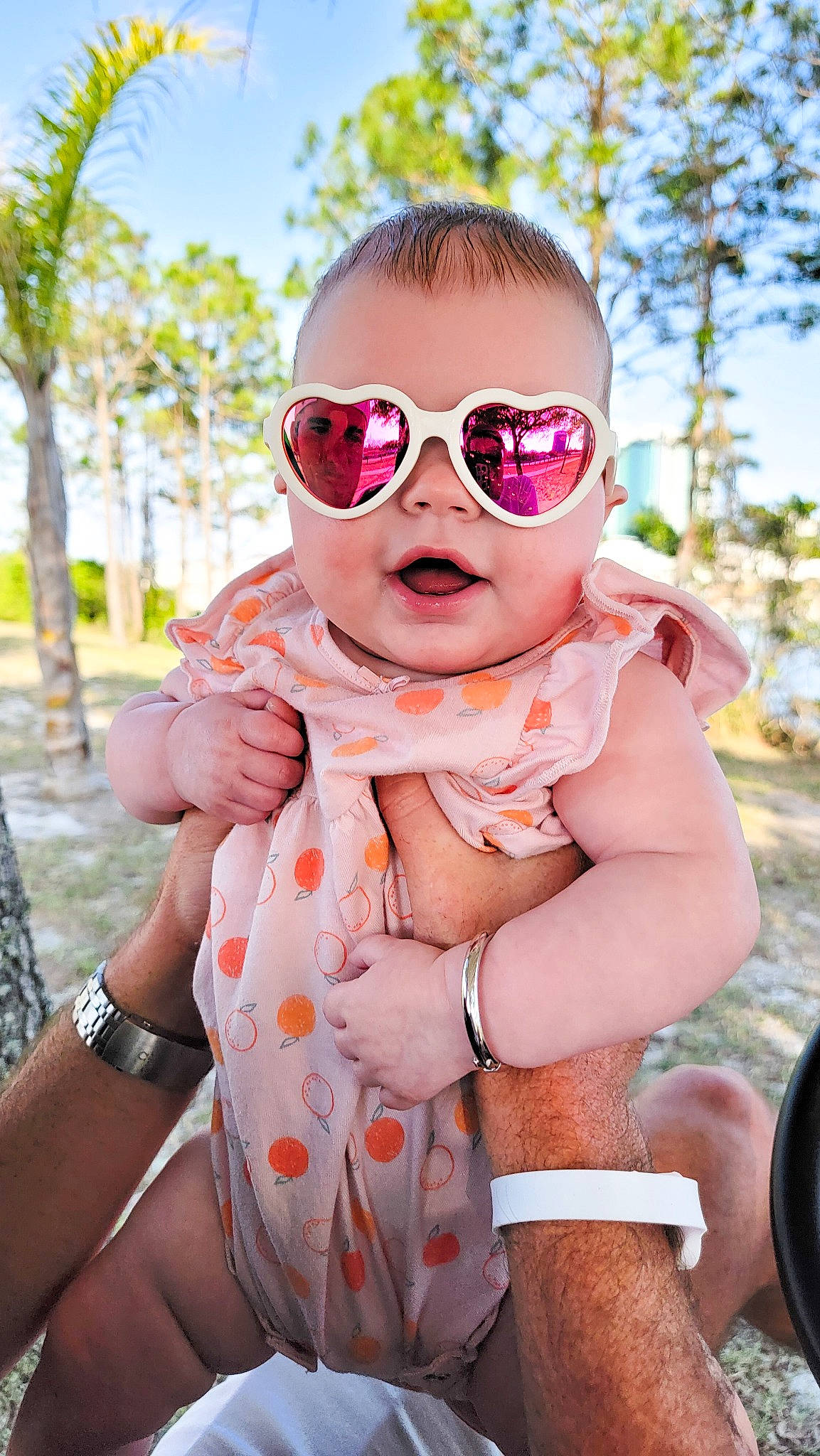 Vivian joined the competition — help win amazing prizes! arm, baby, baby_toddler_clothing, clothing, dress, eyewear, gesture, goggles, grass, hand, happy, lip, person, pink, plant, skin, sky, sleeve, sunglasses, vision_care
