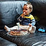 baby, child, cake, birthday, couch, leather, sweater, pants, toy, first_birthday, celebration, food, plate, indoor, curious, sitting, sock, hair, face, hands