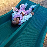 Maëna participe au concours pour gagner de l'argent avec cette photo : child, childhood, cute, doll, excited, fun, happy, jacket, outdoor, park, person, pink_clothing, play, playground, recreation, slide, smiling, sneakers, toddler, toy