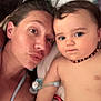 Kevin participe au concours pour gagner de l'argent avec cette photo : woman, baby, face, portrait, selfie, toy, beaded_necklace, blanket, cushion, diaper, tattoo, skin, indoor, closeup, expression, family, child, person, lying_down, playful
