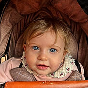 Tahlia joined the competition — help win amazing prizes! baby, bib, blond_hair, blue_eyes, buckle, canopy, child, close_up, cute, eyelashes, fabric_texture, infant, leather_bar, pink_clothing, portrait, rosy_cheeks, seat, smile, stroller, tousled_hair