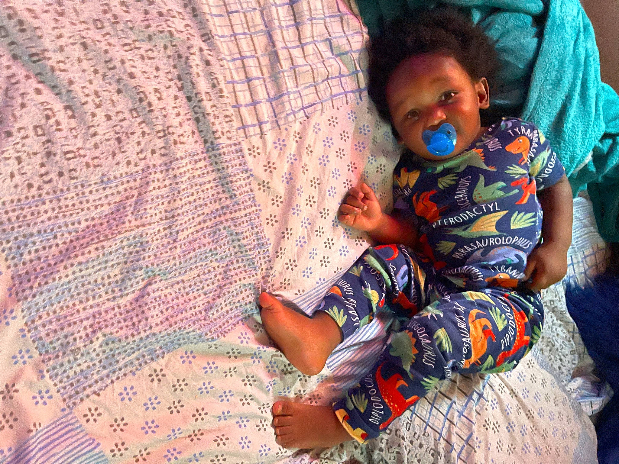 Shaheem is registered to the contest to win money with this photo: adaptation, child, comfort, design, fun, happy, leisure, linens, pattern, person, plaid, purple, room, sitting, skin, smile, textile, toddler, tree, vacation