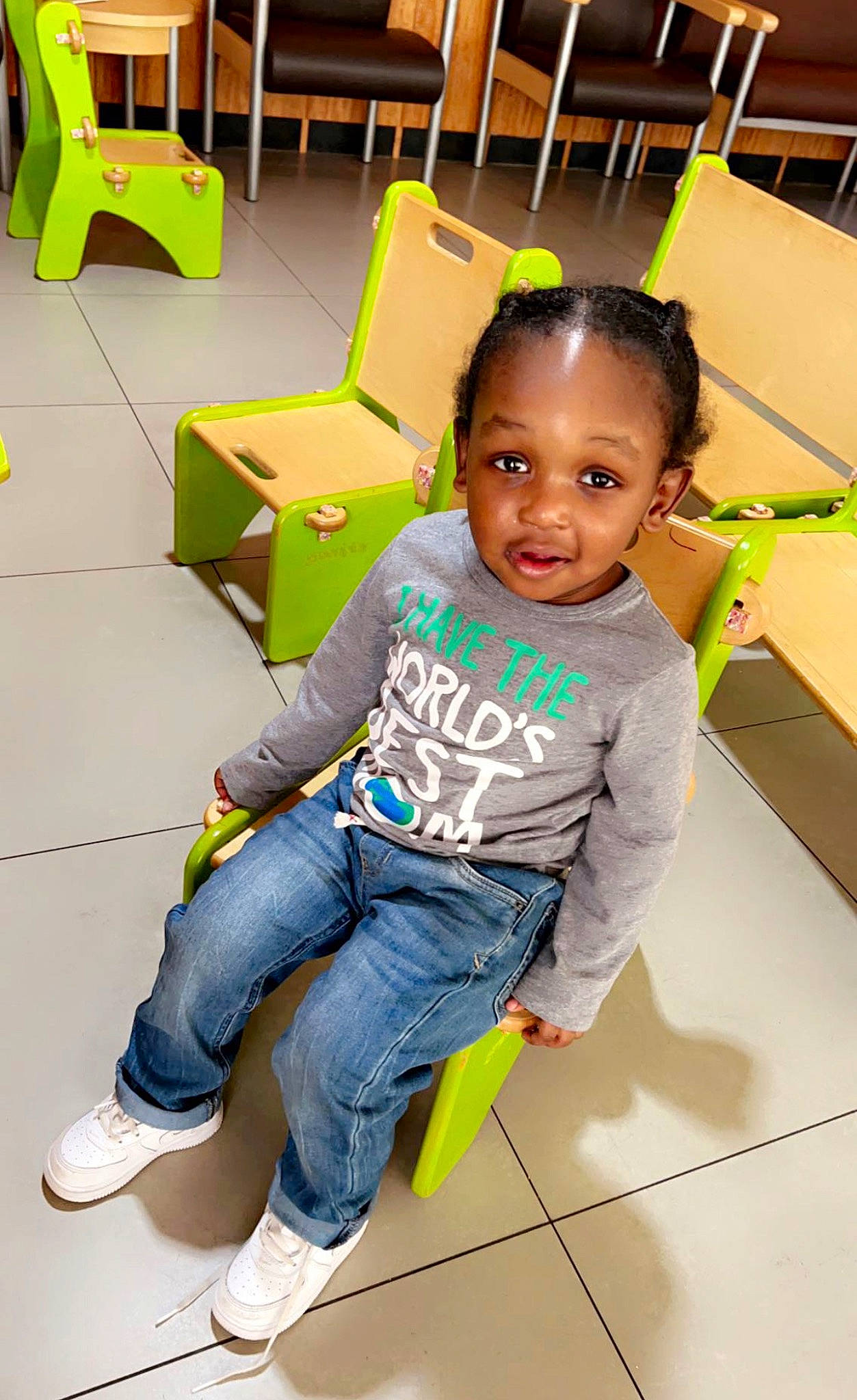 Shaheem is registered to the contest to win money with this photo: baby_toddler_clothing, chair, child, denim, flooring, fun, happy, jeans, leisure, person, play, room, sitting, skin, snapshot, sneakers, t_shirt, thigh, toddler, white