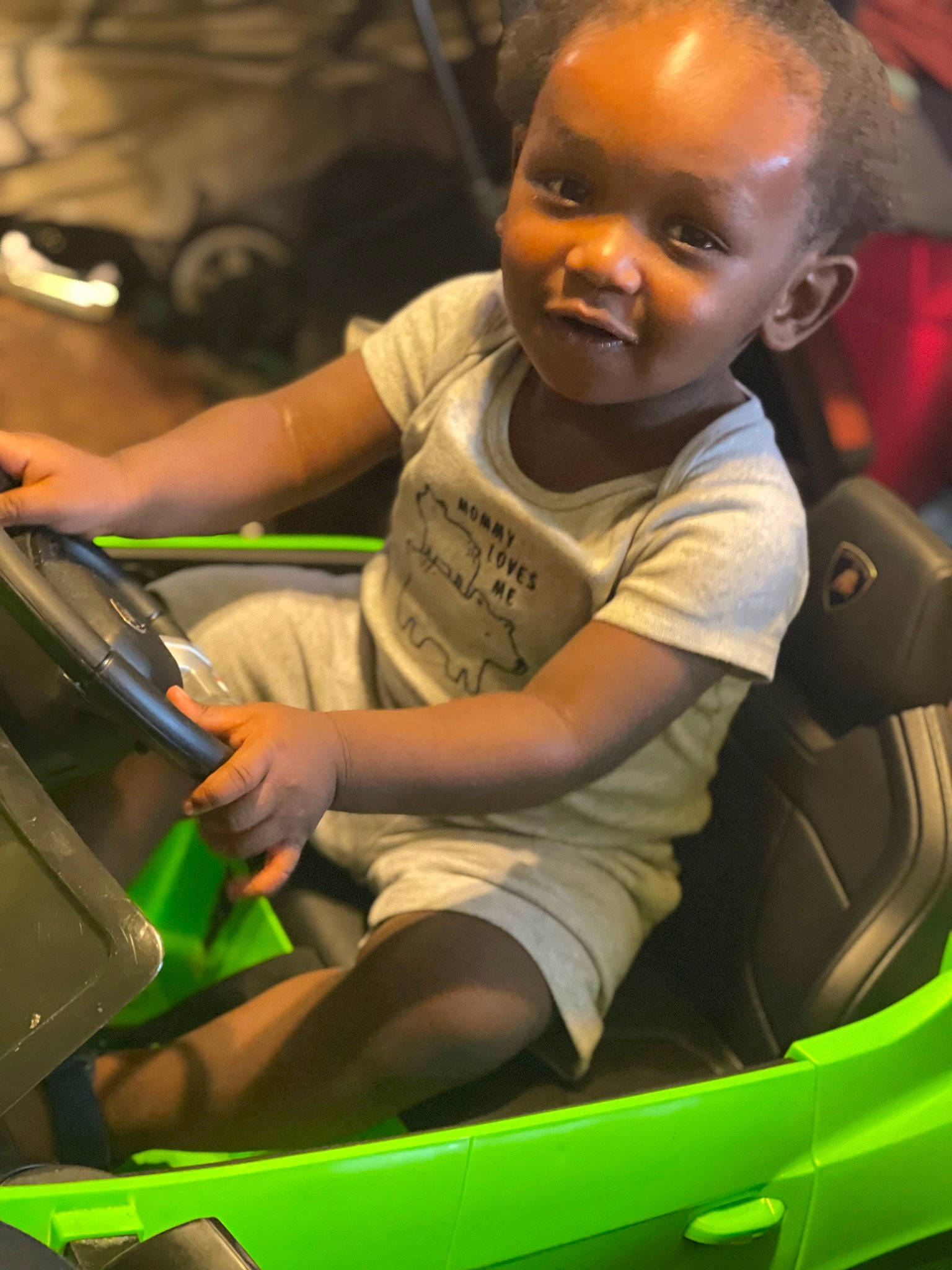Shaheem is registered to the contest to win money with this photo: auto_part, automotive_design, automotive_exterior, automotive_lighting, bumper, car_seat, child, fun, glass, leisure, motor_vehicle, person, product, recreation, sitting, smile, steering_wheel, t_shirt, toddler, vehicle_door