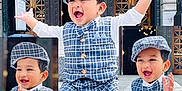 Diyan joined the competition — help win amazing prizes! toddler, child, smiling, clapping, plaid_outfit, cap, sneakers, stone_ledge, outdoor, glass_roof, wooden_doors, happy, person, portrait, fashion, cute, playful, young_child, multiple_poses, daylight