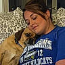 Lucy joined the competition — help win amazing prizes! woman, dog, snuggling, blue_shirt, leopard_print, cushion, indoor, relaxing, pet, companion, casual, comfort, portrait, close_up, affection, resting, happy, human, animal, friendship