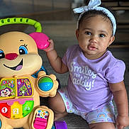 Raya joined the competition — help win amazing prizes! toddler, child, baby, headband, purple_shirt, toy_walker, colorful_toy, smiling_toy, indoor, carpet, playtime, cute, sitting, expression, bright_colors, person, portrait, happy, childhood, floor