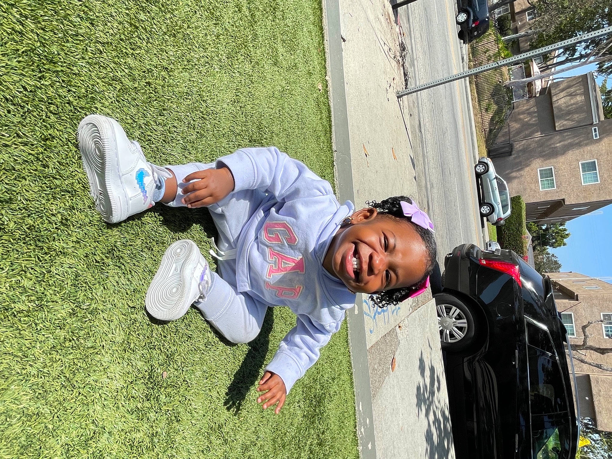 Journie is registered to the contest to win money with this photo: adventure, building, eyewear, foot, fun, grass, happy, human_leg, leisure, people_in_nature, person, plant, recreation, smile, sneakers, sunglasses, toddler, tree, walking_shoe, wall