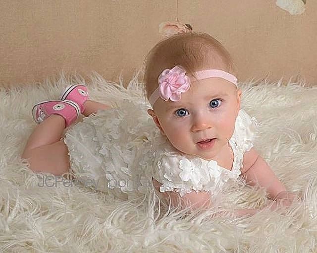 Harley Quinn is registered to the contest to win money with this photo: baby, cheek, child, doll, eye, face, forehead, fur, hair_accessory, head, headgear, iris, lip, person, pink, product, skin, textile, toddler, toy