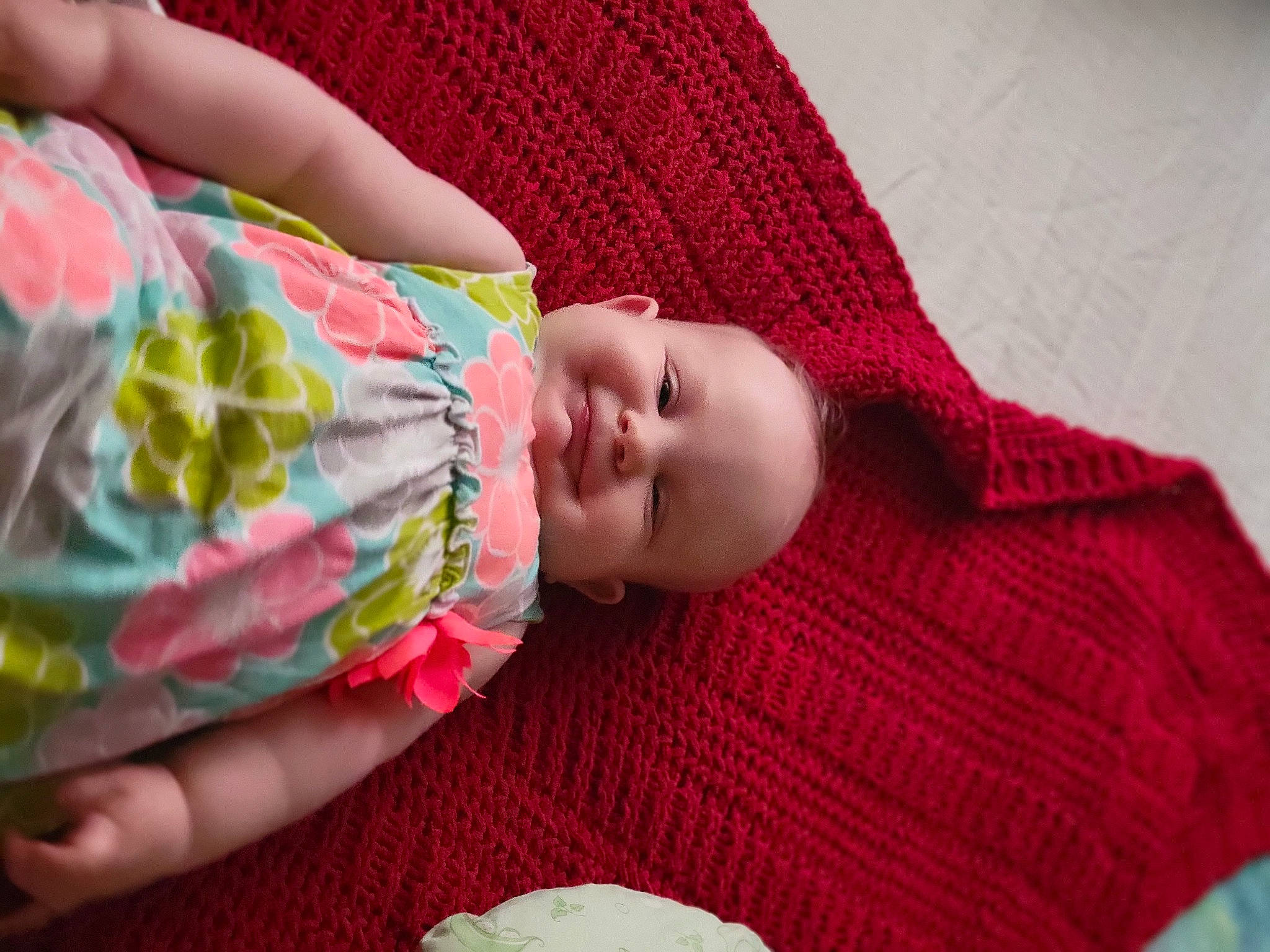 Persephone is registered to the contest to win money with this photo: arm, baby, baby_toddler_clothing, cheek, child, comfort, fashion_accessory, finger, hand, head, joy, linens, lip, magenta, pattern, person, pink, room, skin, sleeve