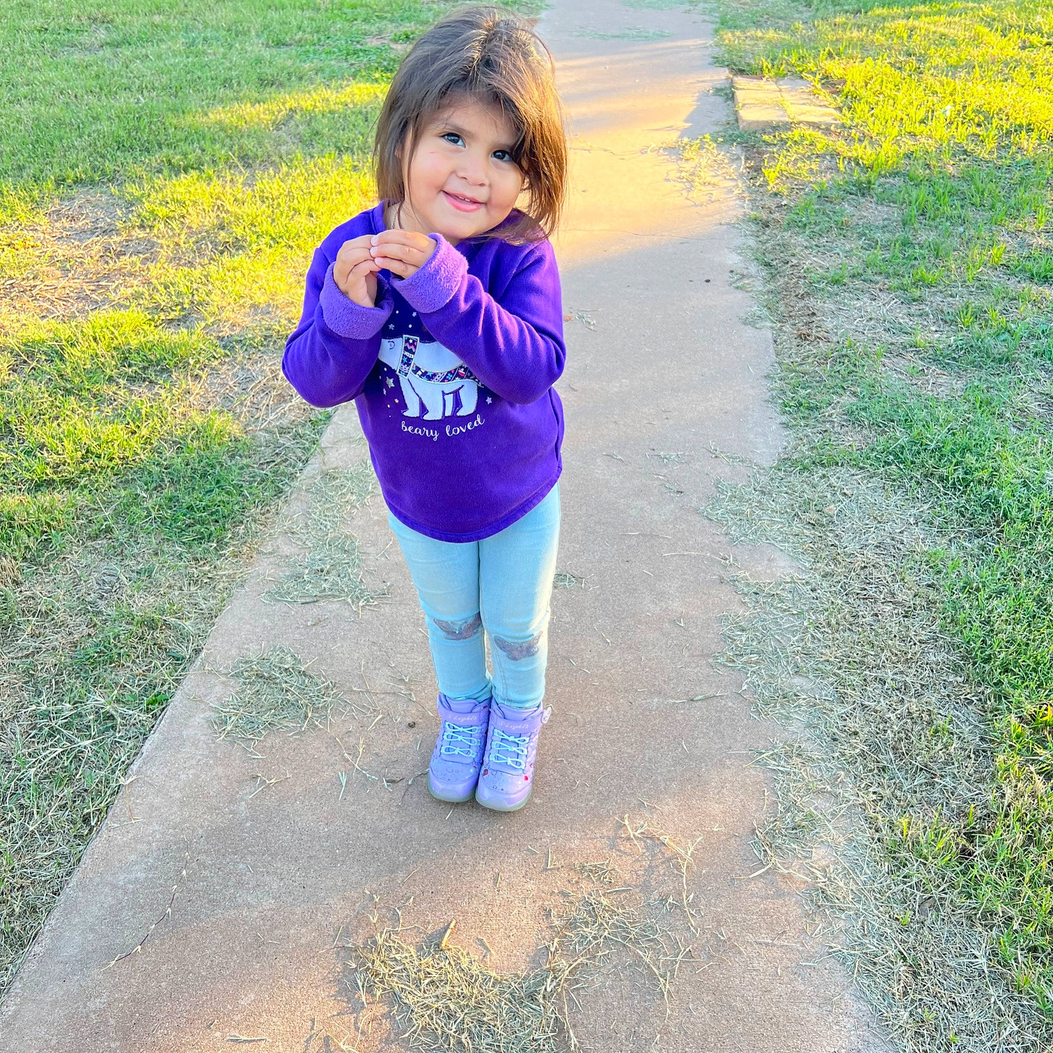 Lorena Luna is registered to the contest to win money with this photo: asphalt, child, electric_blue, grass, grassland, happy, human_leg, joy, leisure, magenta, pattern, people_in_nature, person, plant, recreation, road_surface, sleeve, smile, t_shirt, toddler