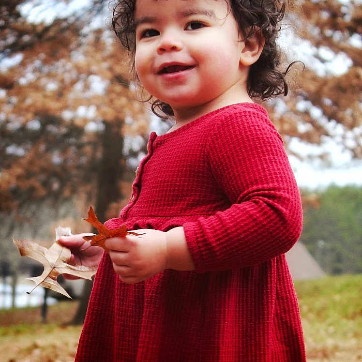Julie joined the competition — help win amazing prizes! bodypart, child, clothing, coat, dress, face, female, finger, girl, hand, head, knitwear, leaf, person, photography, plant, portrait, sweater, tree, vegetation